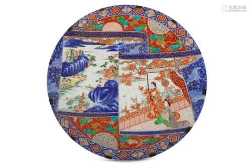 A LARGE KUTANI CHARGER. Meiji Period. Finely painted in various enamels and gilt on underglaze blue,