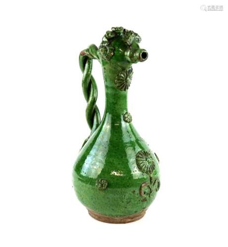 A green glazed Canakkale ewer with rope twist handle, decorated in high relief with a design of