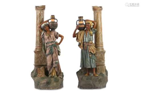 A LARGE PAIR OF EARLY 20TH CENTURY AUSTRIAN PAINTED TERRACOTTA FIGURES OF ARAB WATER CARRIERS