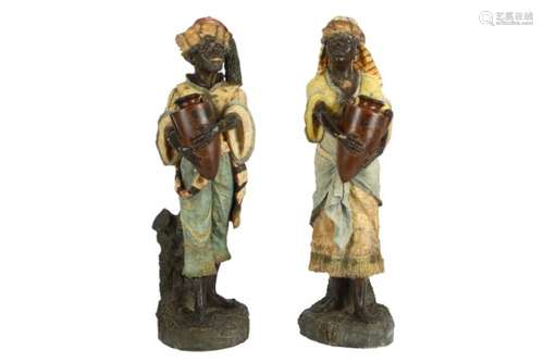 A PAIR OF EARLY 20TH CENTURY AUSTRIAN PAINTED TERRACOTTA FIGURES OF ARAB WATER CARRIERS