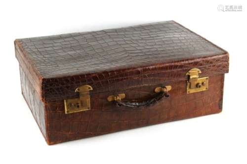 Property of a deceased estate - an early 20th century crocodile skin suitcase, with brass double