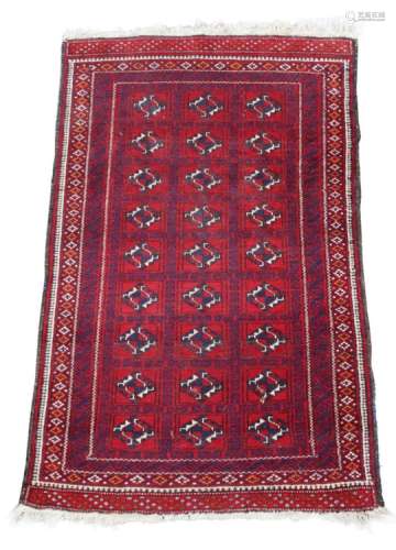 Property of a deceased estate - an Afghan rug with three rows of guls on a red ground, 57 by