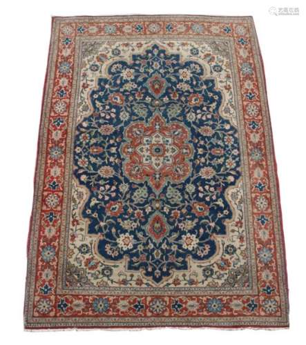 An Isfahan rug, with navy field & ivory spandrels, 80 by 56ins. (202 by 153cms.).