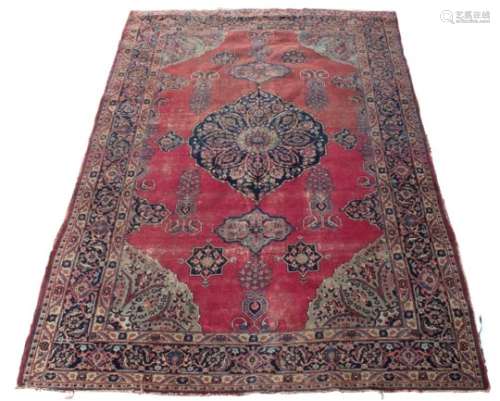 Property of a gentleman - an antique Kirman Laver carpet, worn, 132 by 92ins. (336 by 234cms.).