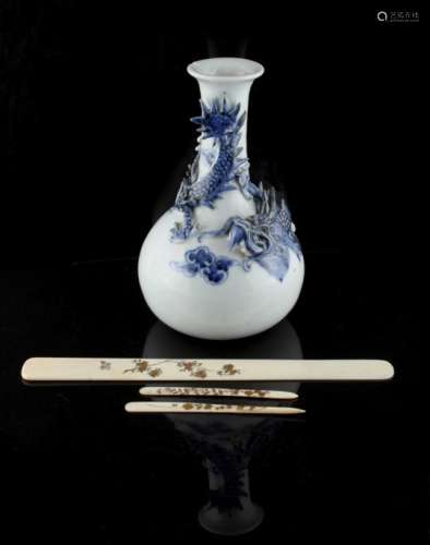 A late 19th / early 20th century Japanese Hirado blue & white bottle vase decorated in relief with a