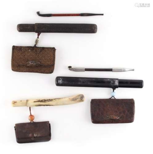 A group of three 19th century Japanese opium pipe cases with purses (two containing opium pipes) (