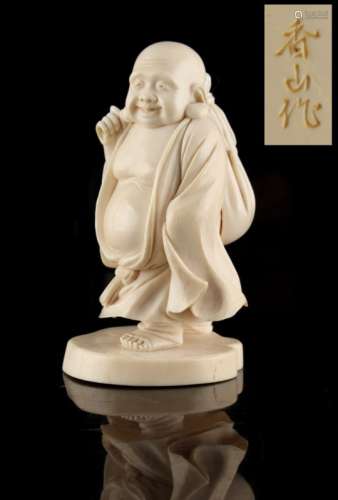 Property of a gentleman - an early 20th century Japanese carved ivory okimono depicting Hotei,