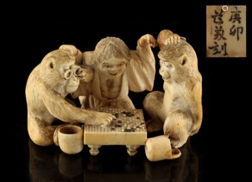 Property of a lady - a Japanese carved ivory okimono depicting a child & two monkeys playing
