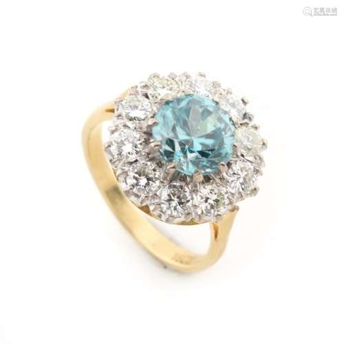 An 18ct yellow gold zircon & diamond cluster ring, the round cut zircon weighing an estimated 2.89