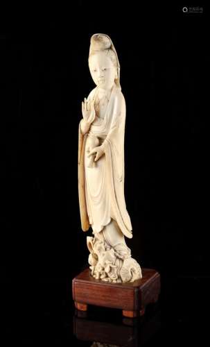 A 19th century Chinese carved ivory figure of Guanyin, modelled standing on a dragon & holding a