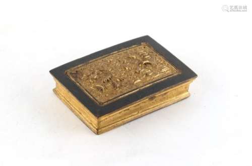 A Chinese gilt bronze rectangular box, 18th century, decorated in relief with a pagoda in a
