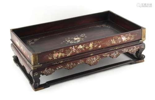 A 19th century Chinese lac burgaute opium tray, 12.25ins. (31.1cms.) long.