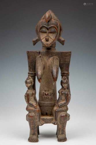 Ivory Coast, Senufo, wooden seated female figure with a child on each kneeProvenance: Huguenin; h.