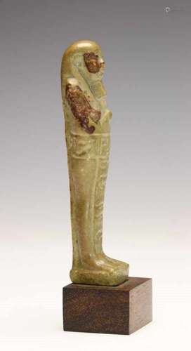 Egypt, faience Ushabti, Late Period,with hieroglyphics, green color and two red collored patches.;