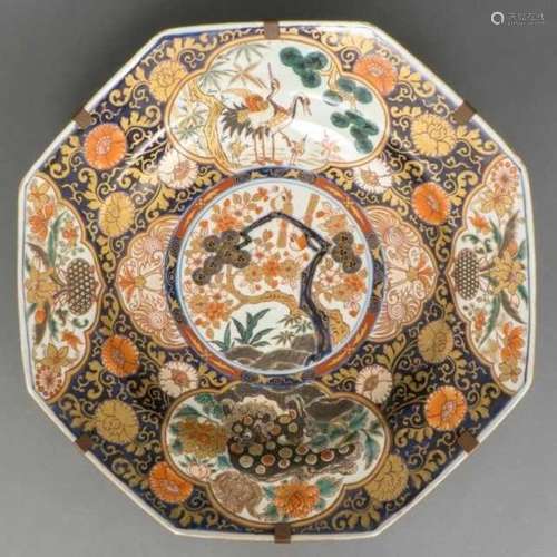 Very large octagonal porcelain dish decorated with birds in a tree, the border with cranes,