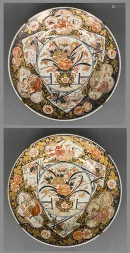 Pair of very large porcelain Imari dishes, each decorated with a richly filled flower vase, the