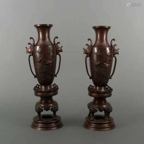 Pair of crimson patinated bronze vases with relief of birds and flowers, the two ears are shaped