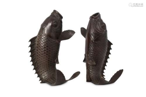A PAIR OF BRONZE CARP VASES. Meiji period. Each formed as a leaping carp resting on its tail, 30cm
