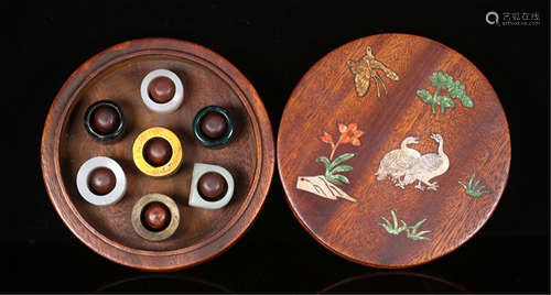 SEVEN CHINESE WHITE JADE AGATE ARCHER RINGS IN HARDWOOD CASE