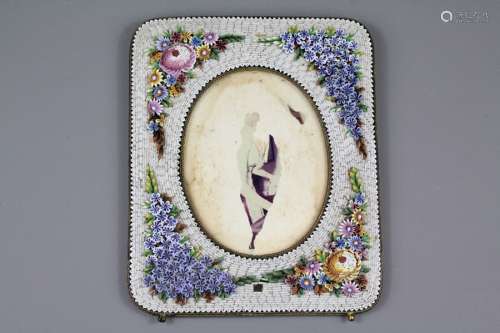 A Micro-Mosaic Photo Frame; the enamel and brass frame encrusted with blue and pink flowers, approx 17 x 20 cms
