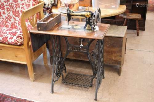 A Singer Treadle Sewing Machine Nr J99055; the sewing machine with one accessory drawer, with flap extended approx 100 x 41 x 74 cms