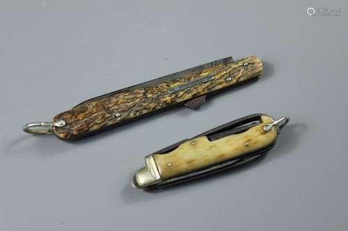 Two Hunting Knives; the first having an antler bone handle, two blades, corkscrew and hook, length (closed) approx 9 cms, the other having an antler bone handle and one blade, length of blade approx 10 cms