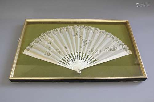 A 19th Century Fan; the fan having ivory sticks with delicate lace and gauze body, extended the fan measures approx 63 x 34 cms, loss evident to the primary stick, glazed and framed, approx 69 x 43 cms