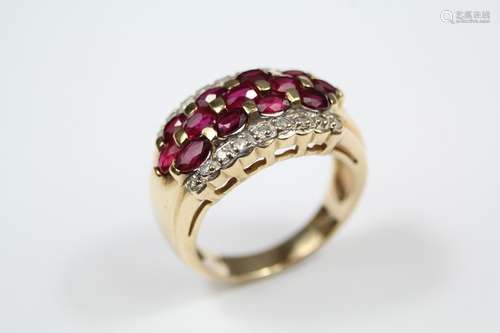 A Lady's 14ct Yellow Gold, Ruby and Diamond Dress Ring, the ring set with thirteen oval-cut rubies, 3 x 2 mm, set within a border of 18 pts of dias, size N, approx 6