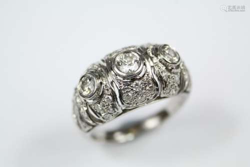 A Lady's Platinum and Diamond Russian Dress Ring, the ring set with 1 x 18 pts and 2 x 16pts of dias, on a fretwork floral mount and further set with 55 pts of pave-set dias, size N, approx 8