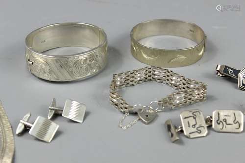 Quantity of Silver Jewellery, this lot includes a silver bangle Chester hallmark, another bangle Sheffield hallmark stamped 925, silver gate-link bracelet with heart-form clasp, three silver cufflinks, Thai silver tie slide and one single cufflink, gross weight approx 159 gms