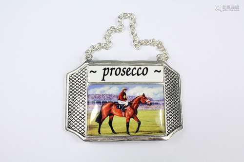 A Silver-Plated and Enamel Proscecco Label, depicting a race-horse