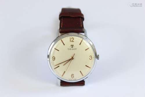 A Tissot Gentleman's Wrist Watch; the watch having a champagne face with numeric and baton dial, on brown leather strap