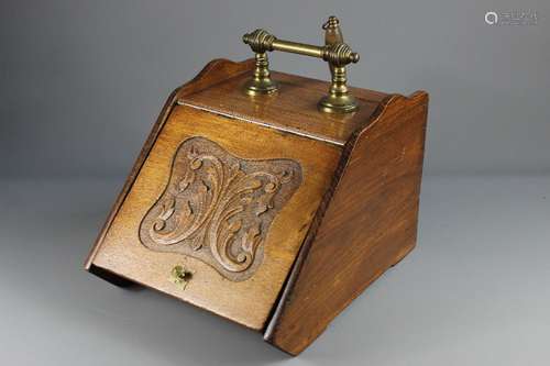 An Oak Coal Box; the coal box having decorative carving to lid, brass handle and shovel, approx 32 x 43 x 28 cms