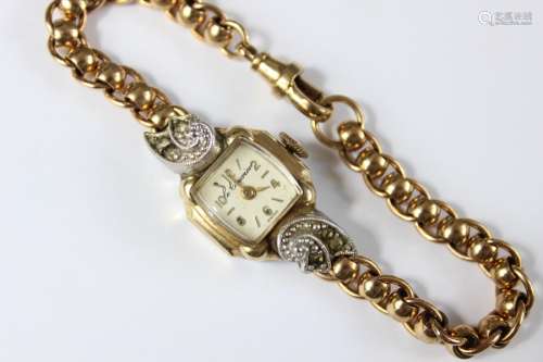 A Lady's Le Courier Cocktail Watch; on 9ct fob chain bracelet, champagne face with numeric and baton dial