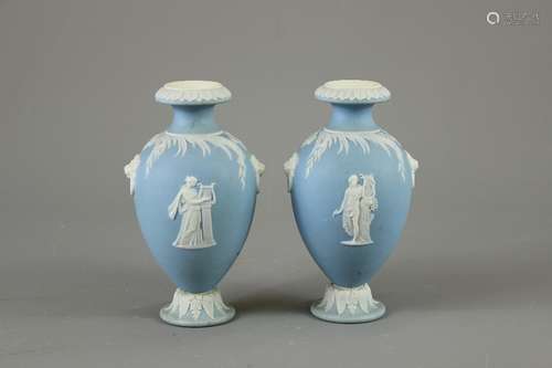 A Pair of Wedgwood Urns; the urns decorated in the classical style with lion mask rings, approx 15 cms h, impressed factory marks to base