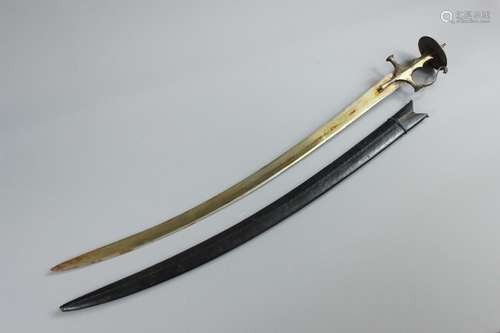 A 19th Century Indian Sub-Continent Talwar, having single edge curved blade, with brass grip with knucklebow, steel disc pommel with a short protruding spike, approx 82 cms, complete with a black stitched leather scabbard