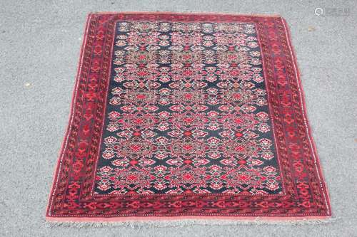 Antique Persian Wool Carpet, having a Navy and Red colouring, approx 164 x 139 cms, selvedges and tassels worn but complete