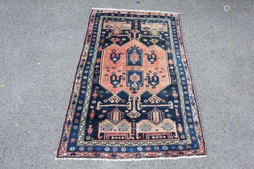 A Circa 1920 Wool Carpet Shaswan Wool Carpet, the carpet having a navy blue ground geometric design depicting figures and animals to border, approx 200 x 120 gms