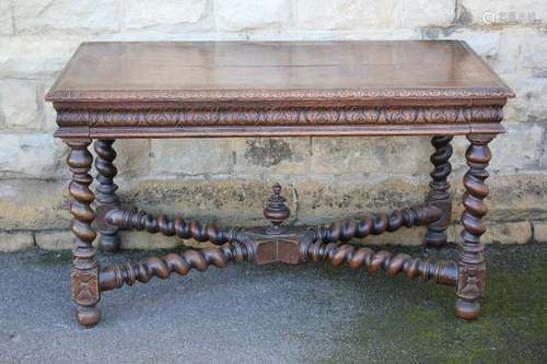 An Antique Oak Side Table, with decorative carving to table edge and skirt, attractive barley-twist turned legs and x-framed barley-twist stretchers, approx 130 x 70 x 73 cms