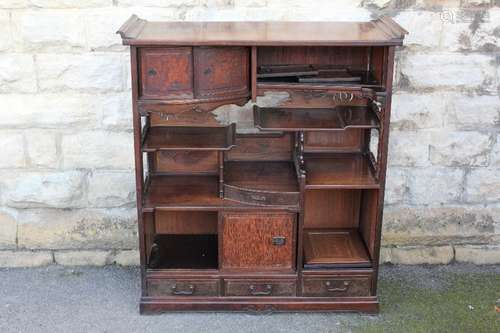 A Japanese Hard Wood and Oak Display Cabinet; the cabinet having two shelves to front with sliding doors, three sliding cupboard doors underneath, five open shelves to front and three small drawers below; approx 99 x 39 x 110 cms