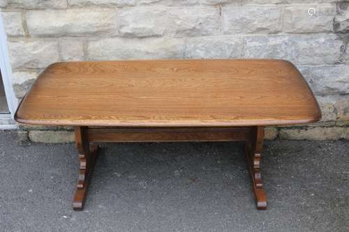 An Ercol Teak Coffee Table; the table having two decorative supports with stretcher, approx 128 x 67 x 51 cms