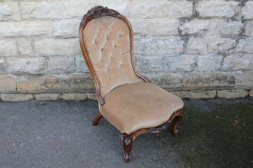 A Walnut Framed Nursing Chair, with gold upholstery