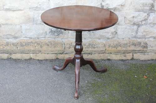 Antique Tilt-top Wine Table; the table a turned central column terminating on tripod base, approx 71 x 71 cms