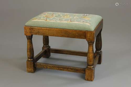 A Victorian Footstool, with tapestry turquoise-coloured floral design, turned legs with stretchers, approx 43 x 30 x 34 cms