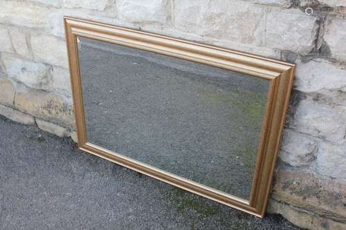 A Gilt Framed Mirror; the bevelled mirror surrounded by a plain gilt frame, mirror approx 90 x 60 cms