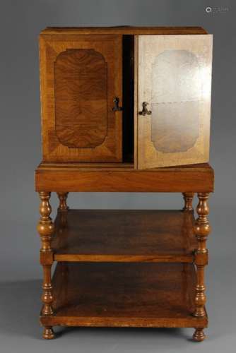 A Smoker's Cabinet; the cabinet on walnut stand, inlaid top with rotating ashtray emptying into a metal box beneath