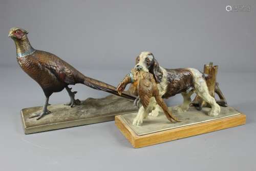 Bronzed and Painted Quill Holder depicting a pheasant; the pheasant standing on a base approx 25 x 10 cms (af), together with a figure of a spaniel with a pheasant in its mouth, standing on a base approx 30 x 9 cms (af)