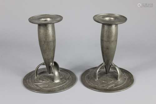 Liberty - Pair of Turdric Pewter Candlesticks; the bullet-shaped candlesticks resting on tripod supports and floral base, approx 14