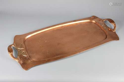 An Art Nouveau Copper Tray; the tray having beaten copper effect base and decorative handles, approx 64 x 27 cms