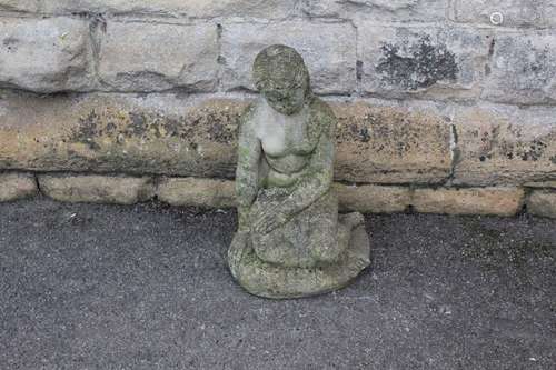 Garden Statuary, this lot includes a figure of a seated girl, approx 37 x 47 x 27 cms,  a Buddha Head; the head approx 12 x 23 cms and stone plaque depicting the three graces approx 36 x 35 cms